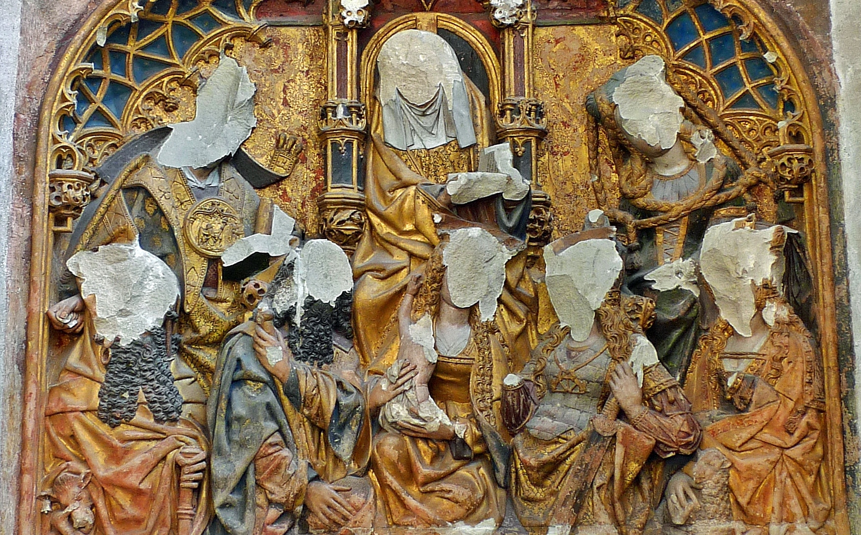 Relief in Utrecht Cathedral, desecrated in 1566 during the iconoclasm in the Netherlands  (a headless baby Jesus held by His now headless mother at center).